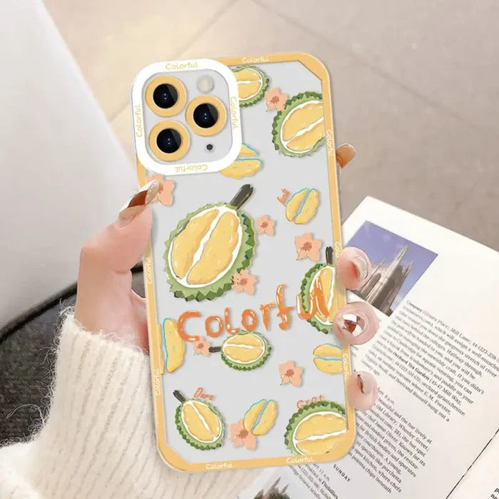 a woman holding a phone case with a lemon pattern